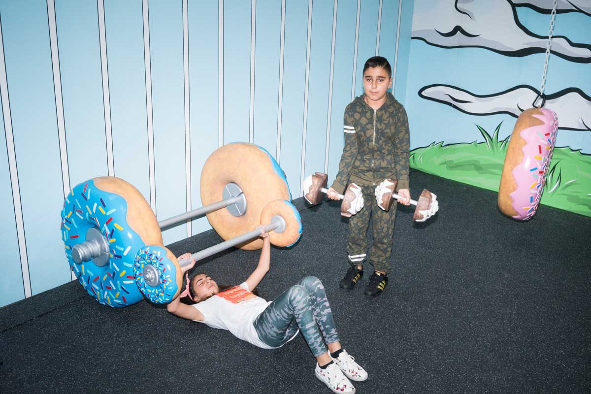 Children lift weights shaped like donuts