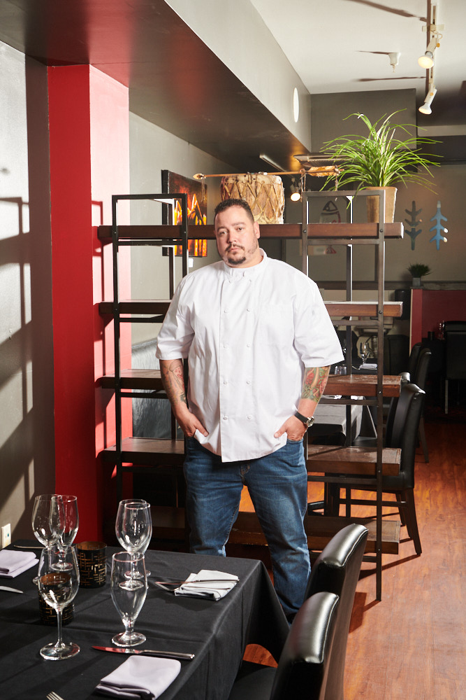 A portrait of chef Brother Luck in his restaurant