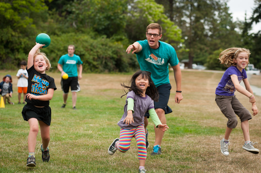 Campers play dodgeball with a counselor