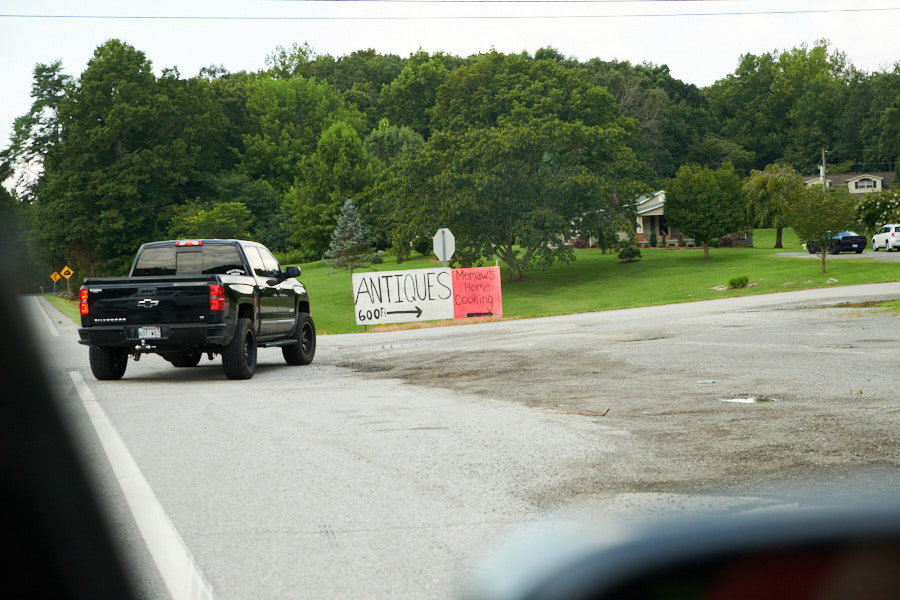 A car turning into a yard sale