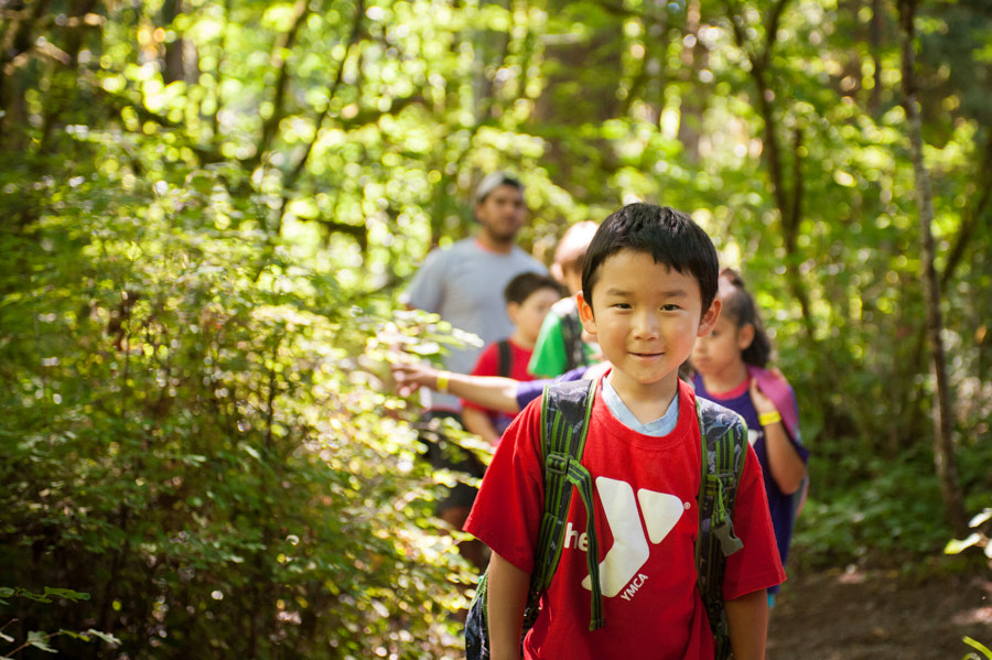 A line of children in the woods