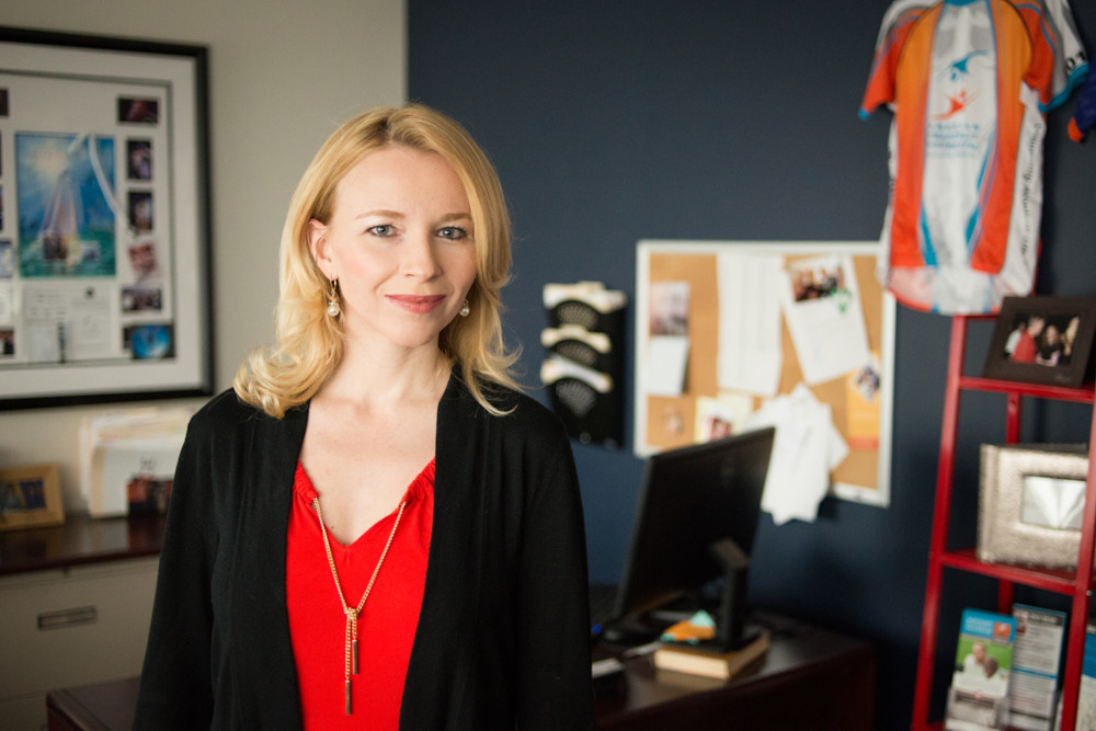 A businesswoman poses for a portrait in her office