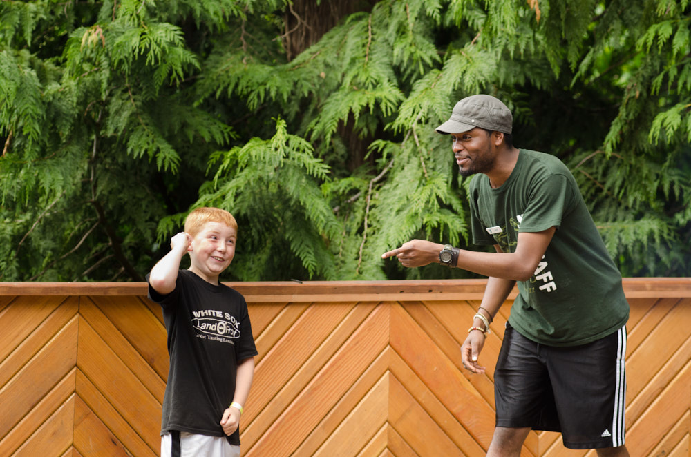 A counselor and camper perform a skit onstage