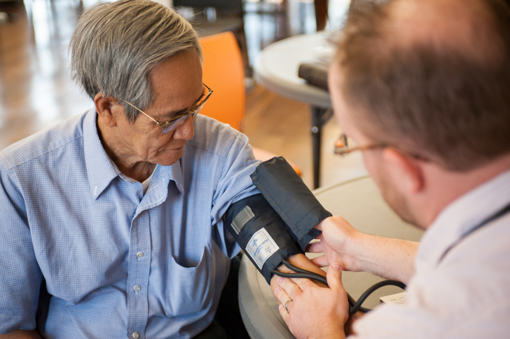 A doctor administering a blood pressure test to a patient