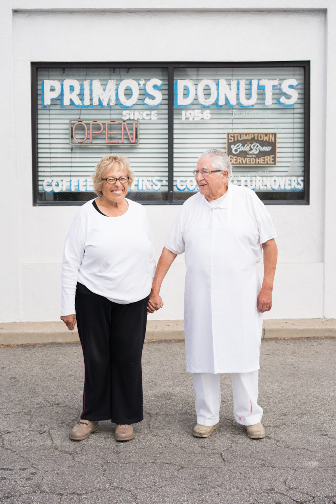 A portrait of Ralph and Celia Primo outside their shop, Primo's Donuts