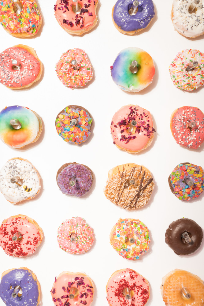 Colorful decorated donuts on a pegboard