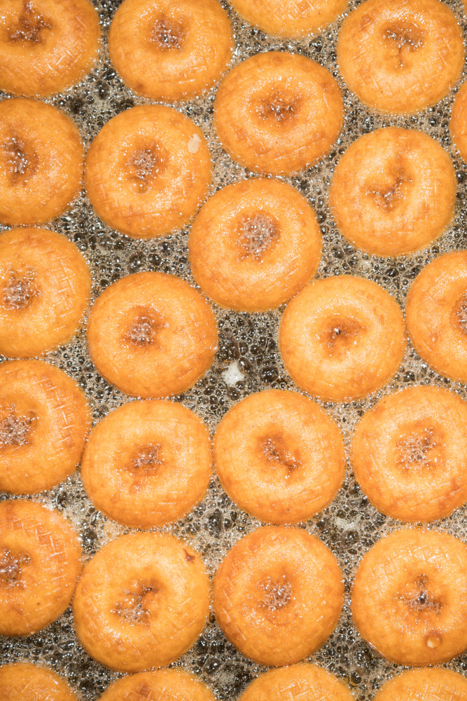 Golden donuts frying in bubbly oil