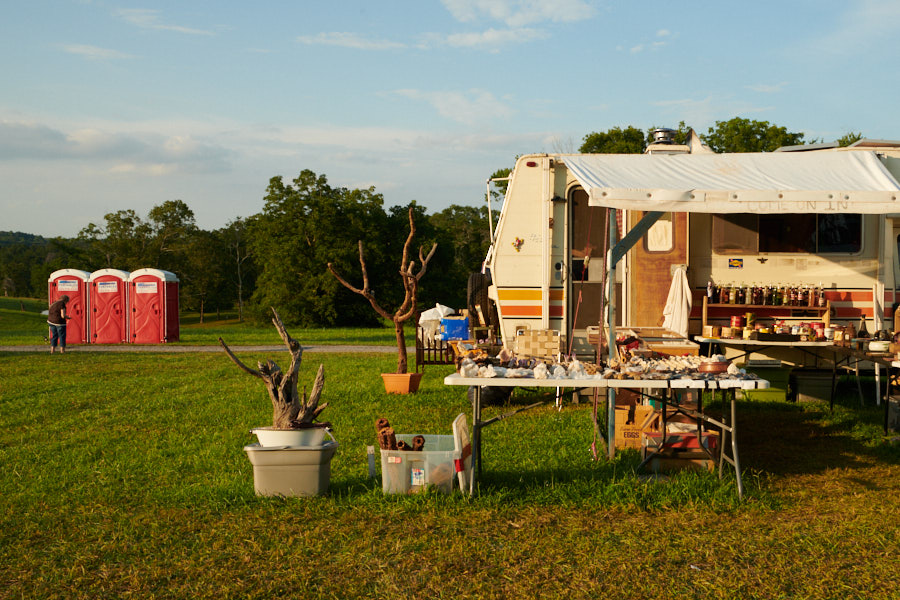 Eclectic yard sale items and porta potties