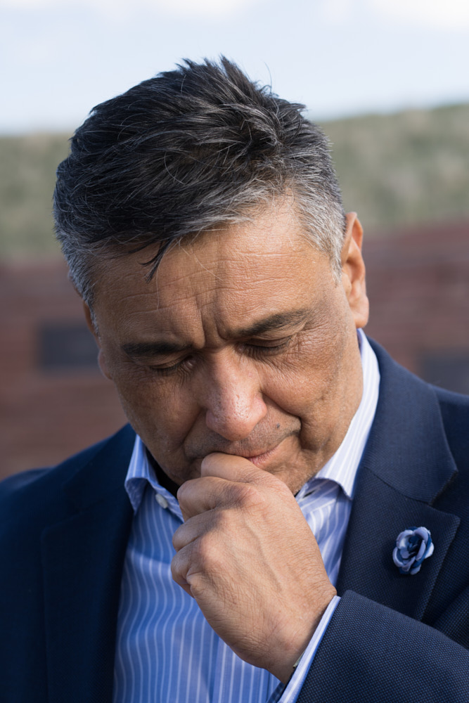 A portrait of Kiki Leyba looking downwards at the Columbine Memorial