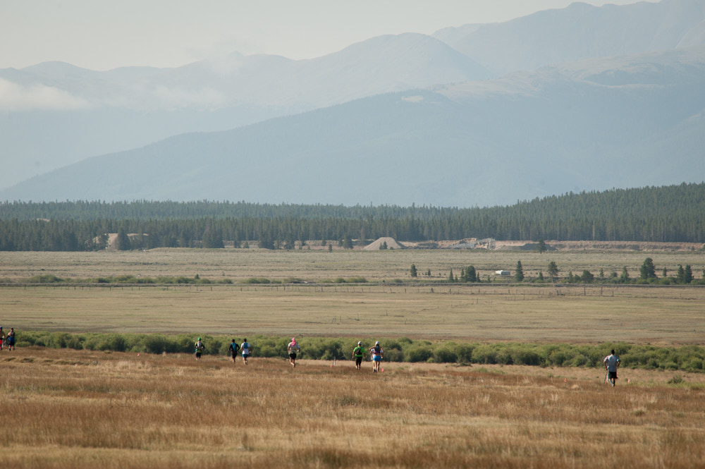 Racers running with mountains in the background