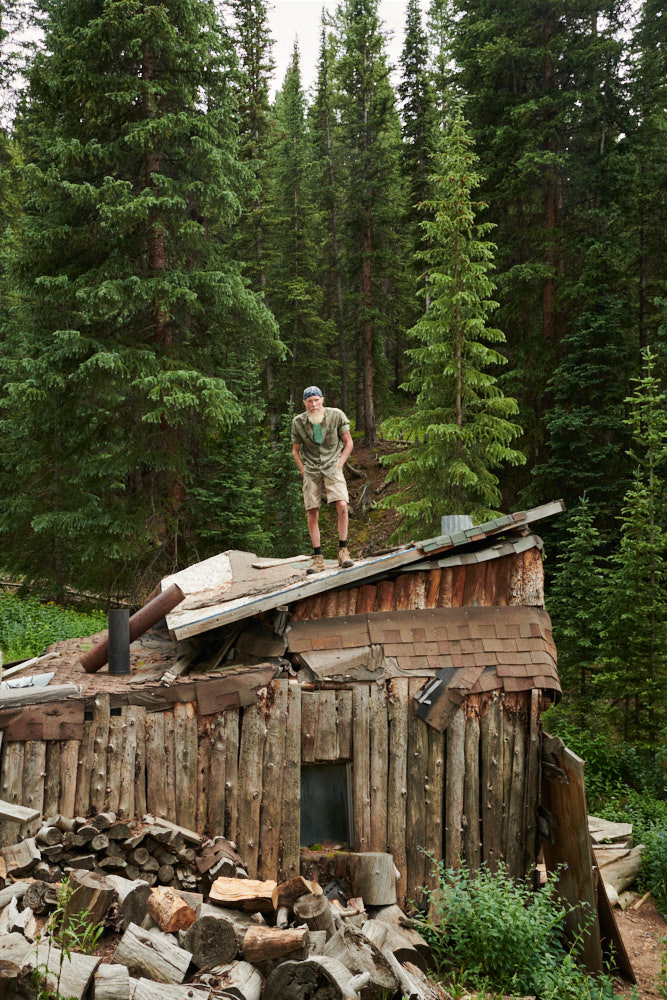 A man standing atop his former home