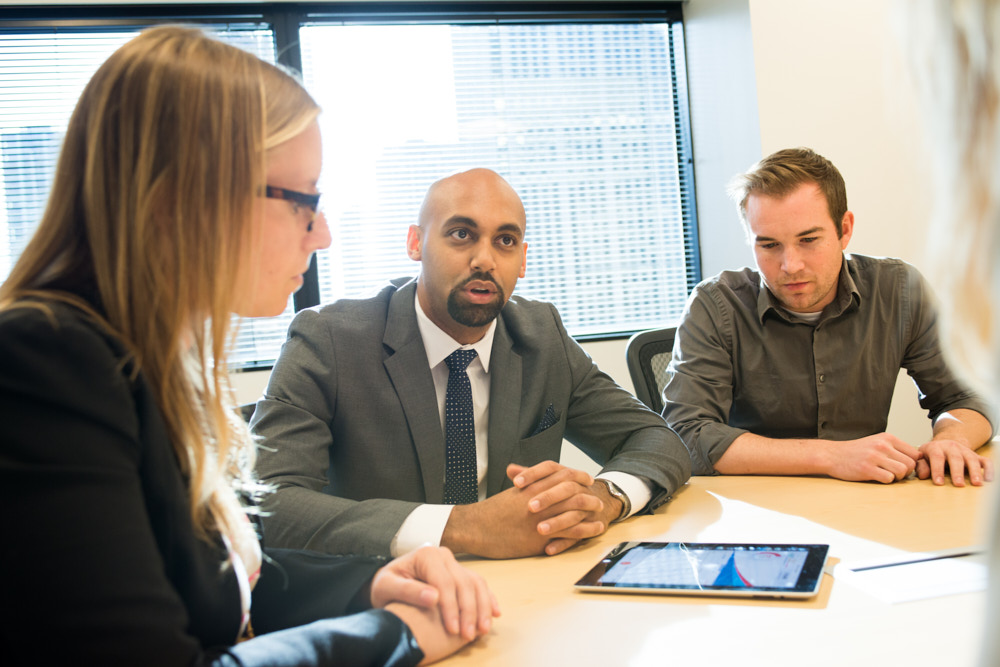 A meeting with coworkers collaborating using a tablet