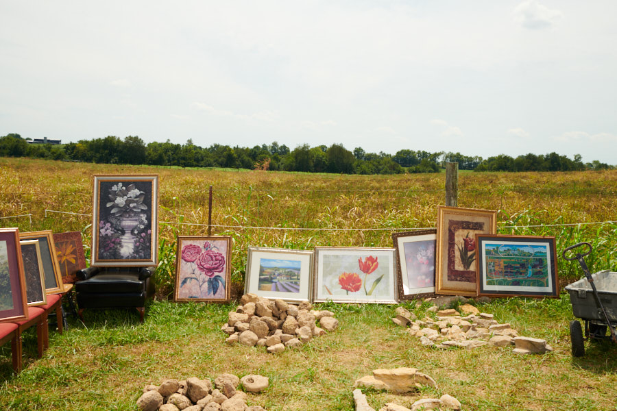Paintings and rocks for sale in a field