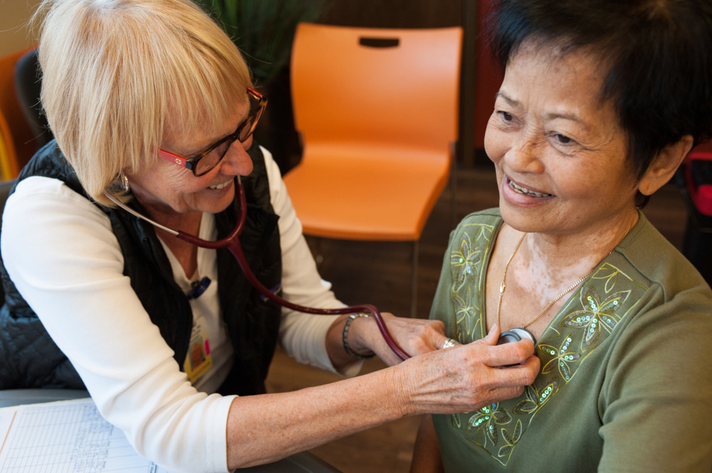 A doctor listening to a patient with a stethoscope