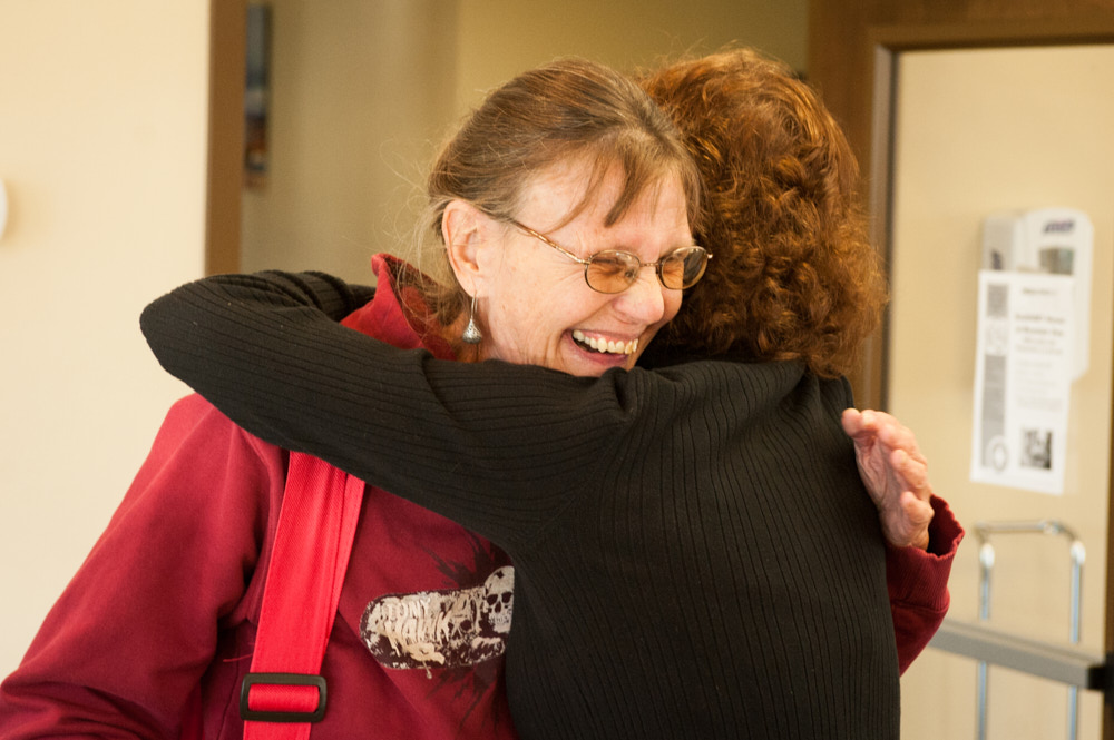 Patients hugging at a clinic