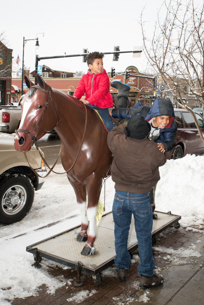 Children playing on a horse statue in Steamboat