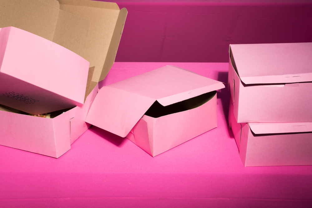 Pink donut boxes on a pink tablecloth