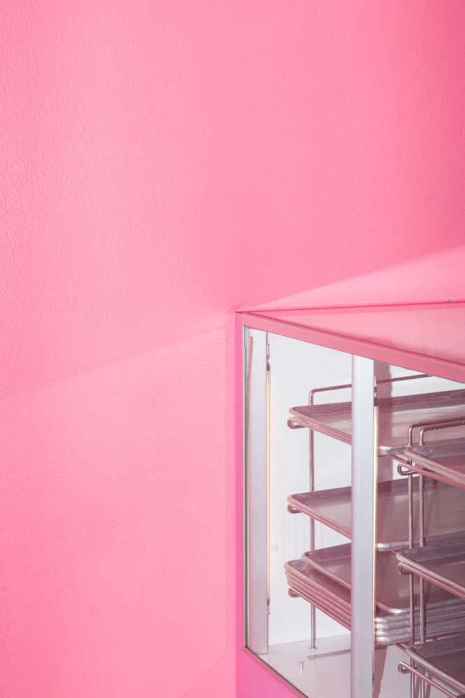 A pink wall and empty display case