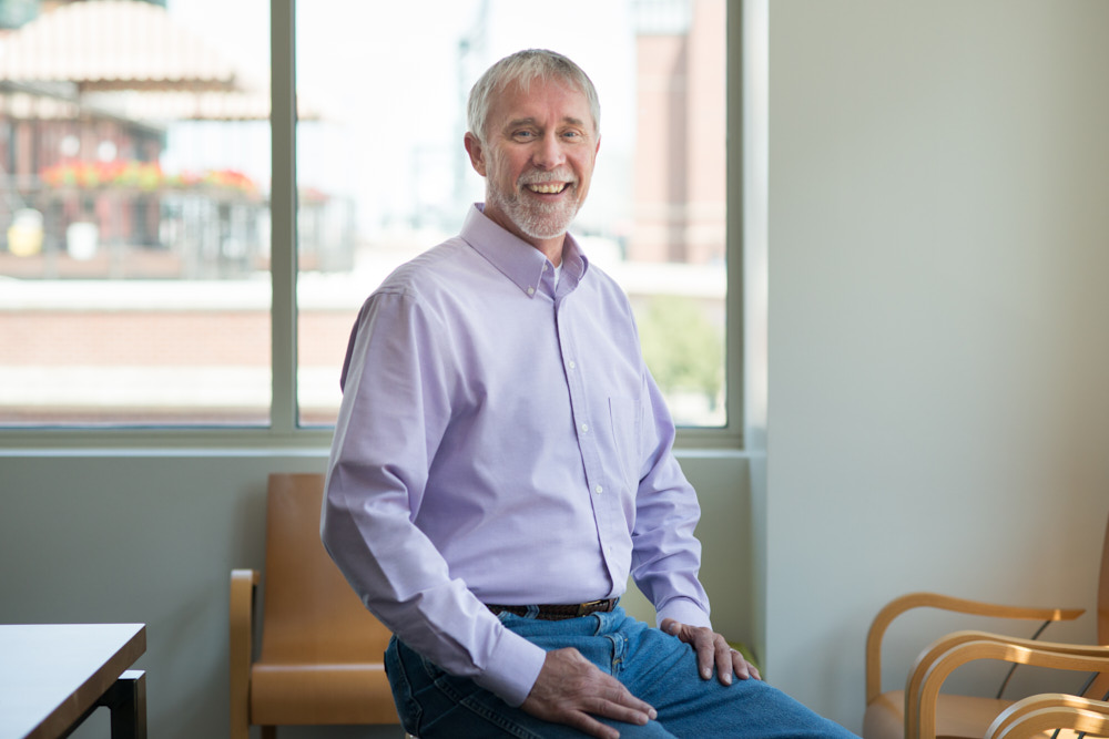 A man smiling in a conference room