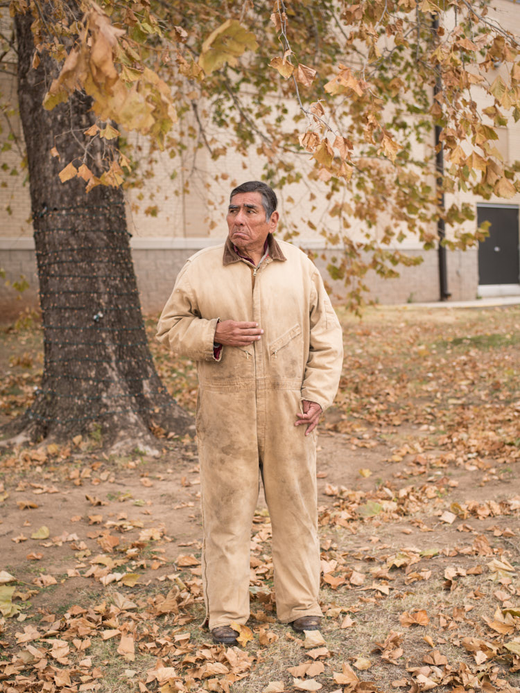 A portrait of a man in a brown jumpsuit