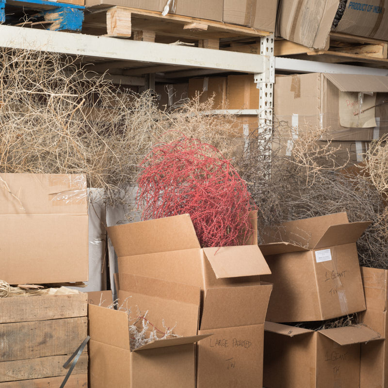 A painted red tumbleweed in a warehouse