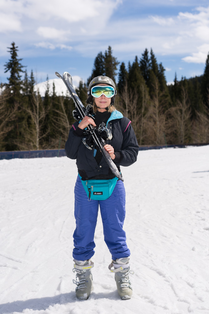 A skiier with a fanny pack posing for a portrait