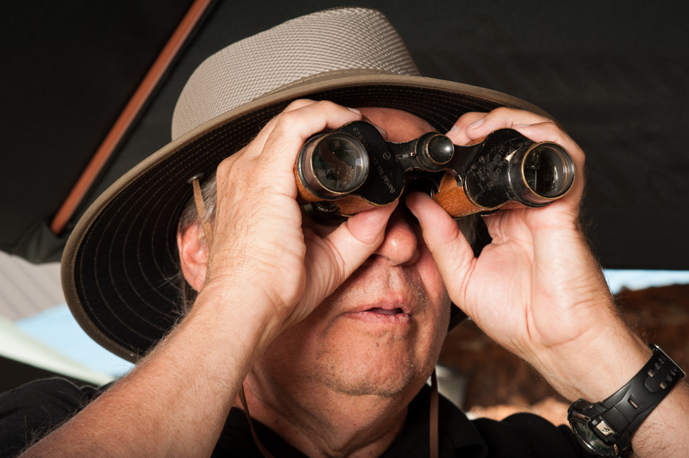 A spectator using old fashioned binoculars