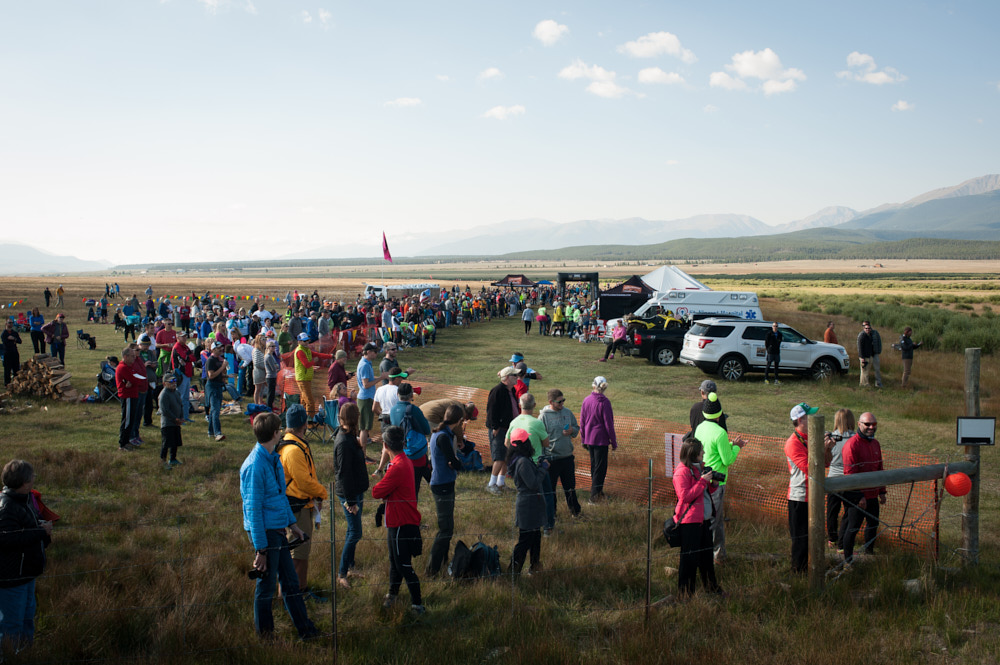 Spectators and crew members stand on the Leadville 100 race course