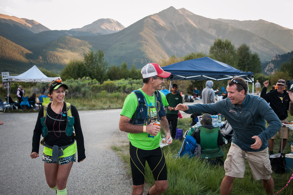 A male runner receives encouragement from a spectator