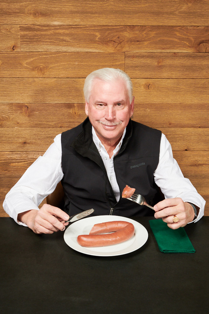 Steve Hughes eating a sausage