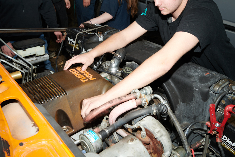A student working on a car