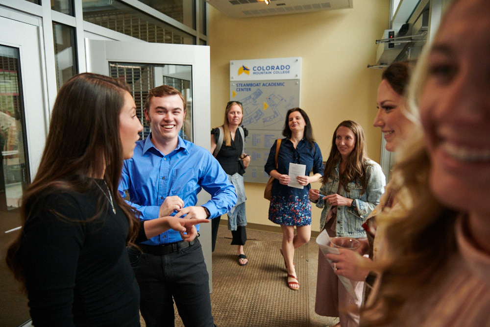 Students gather and smile in a lobby