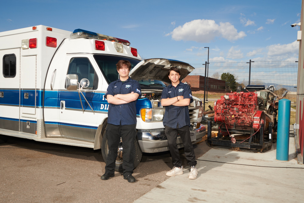 Students posing in front of an ambulance