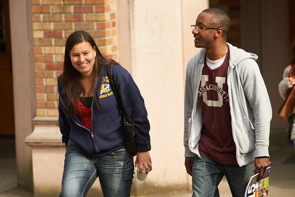 Two students walk outdoors on a college campus