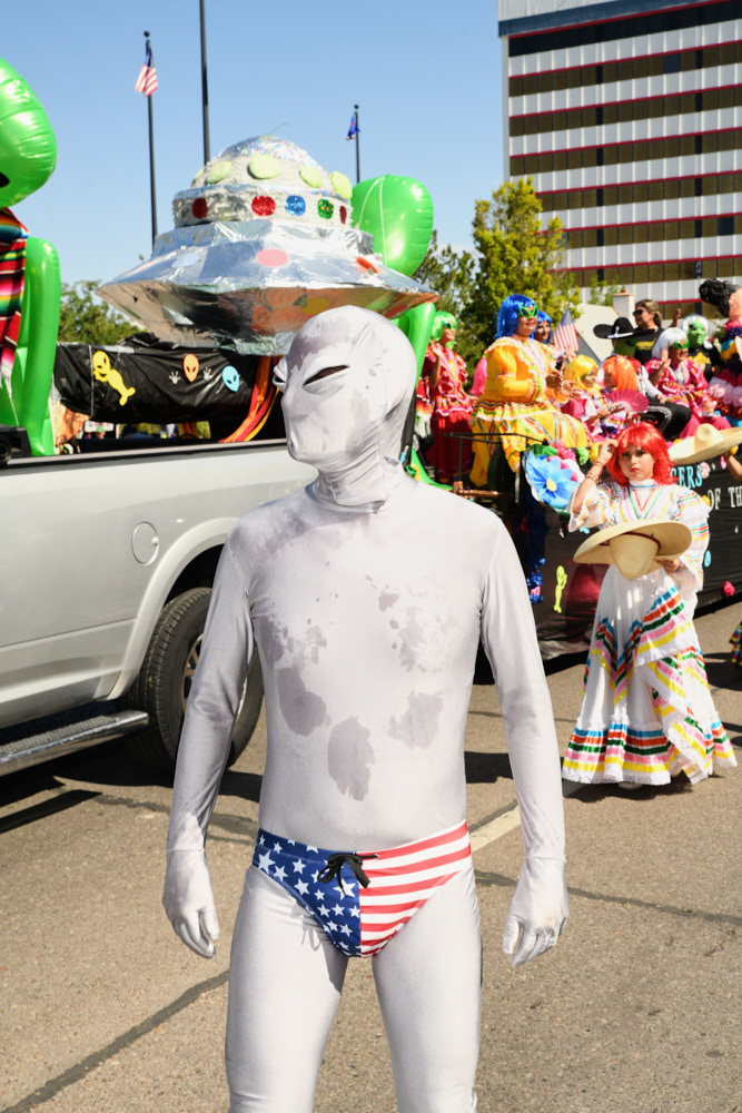 A sweaty costumed alien during a parade