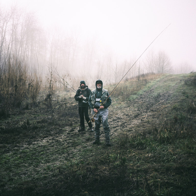 A portrait of two fishermen on a foggy morning