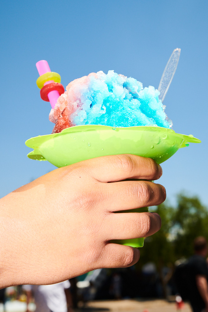 A hand holding a UFO shaped sno cone