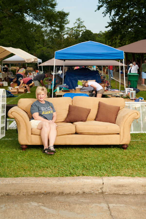 A portrait of a woman sitting on a couch for sale