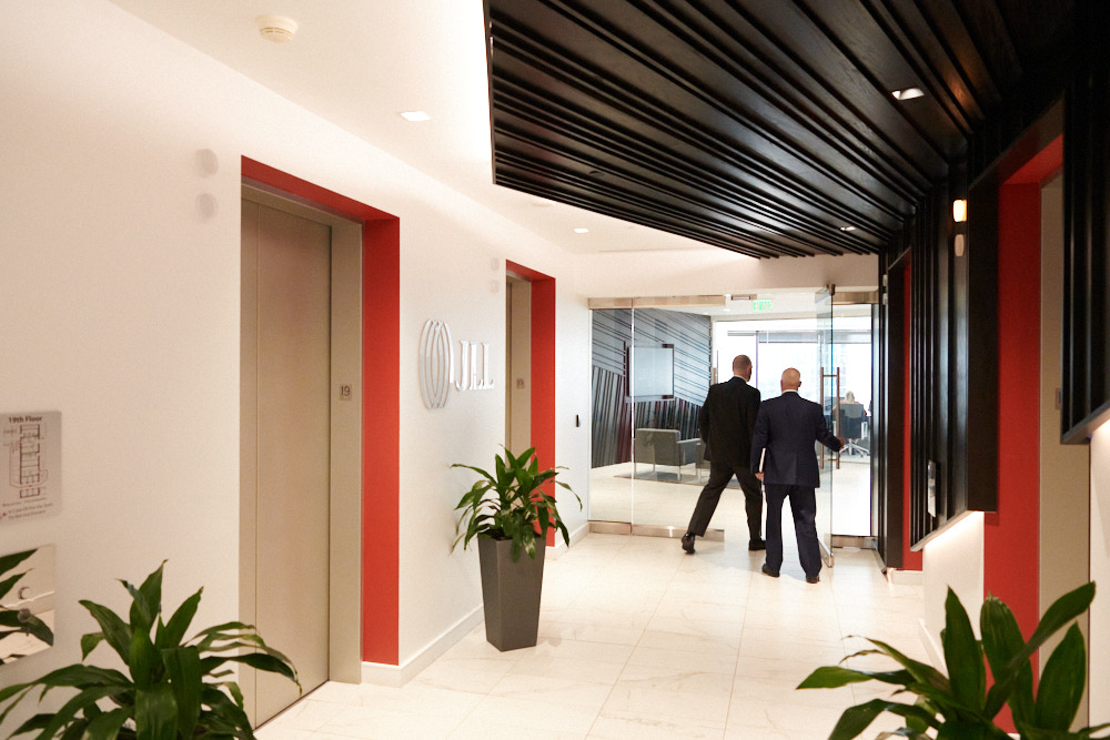 Workers enter an office from an elevator