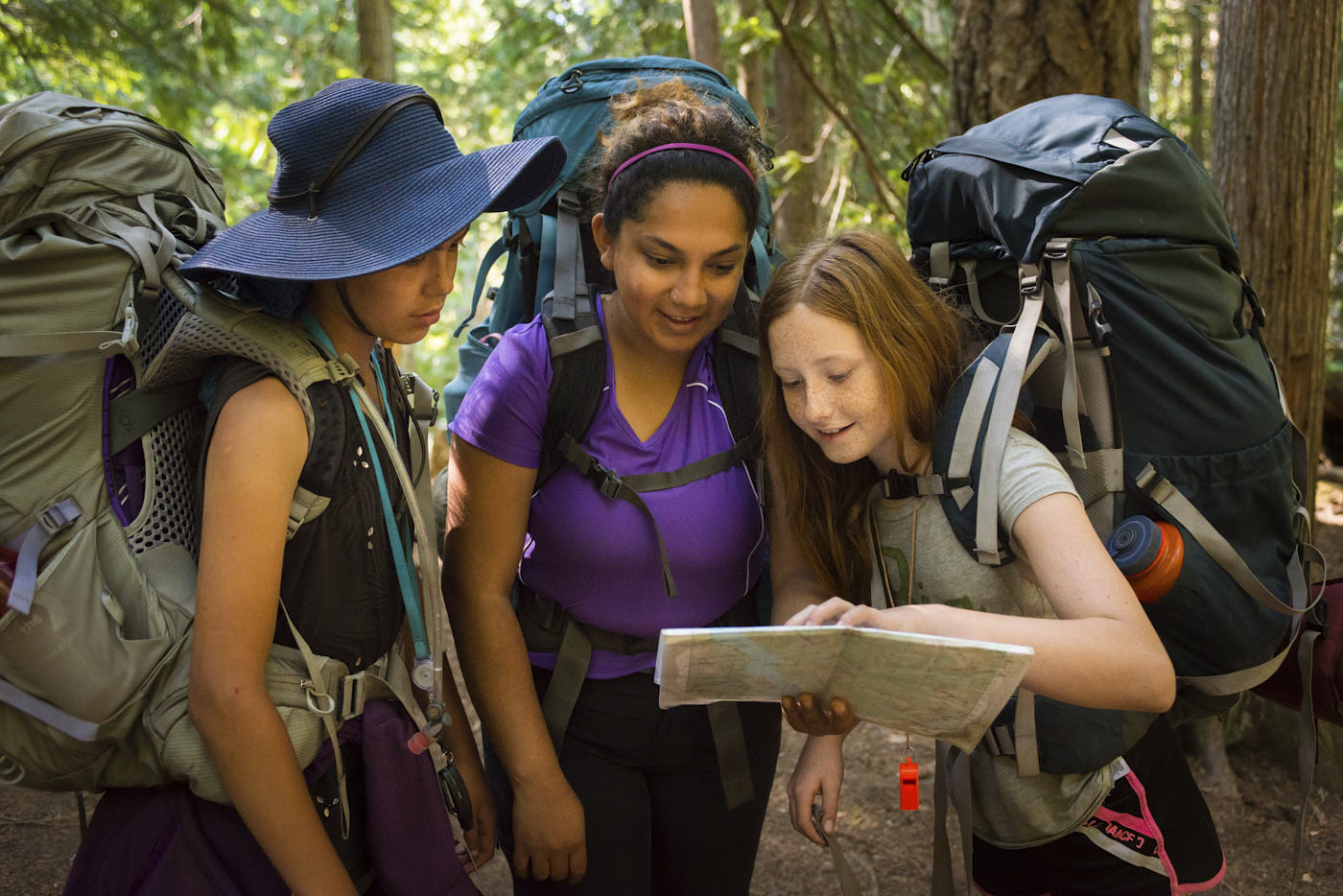 Backpackers looking at a map in the wilderness