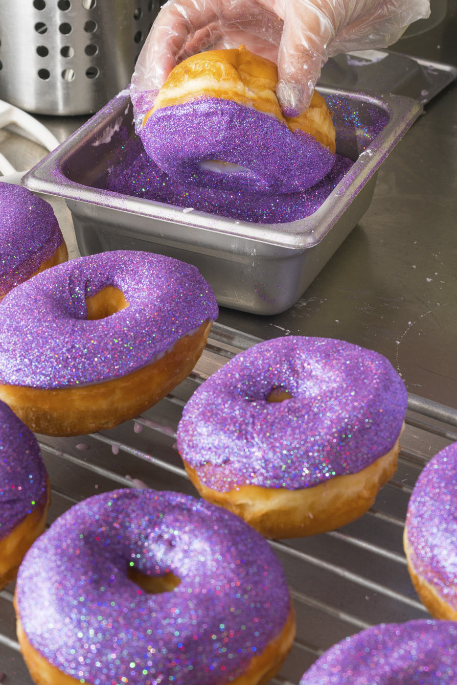 Glitter donuts being prepared at Donas