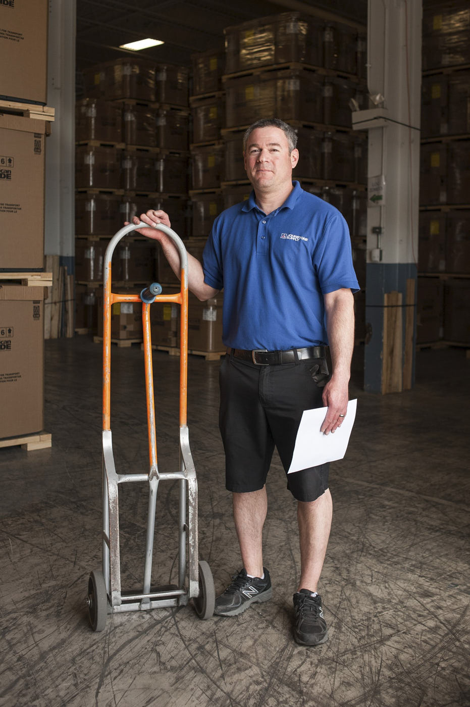 06-man-with-dolly-in-warehouse-portrait