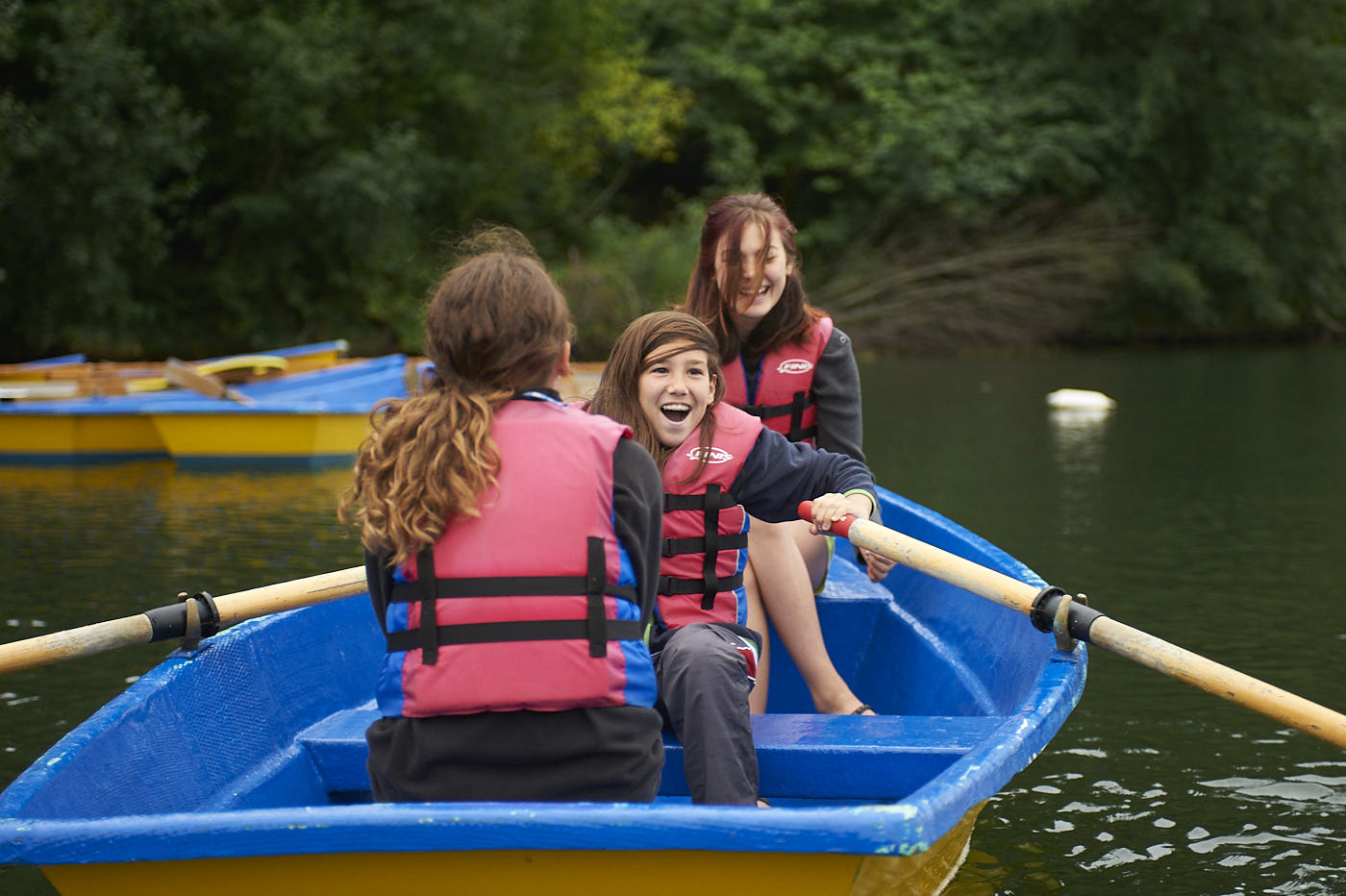 three-young-women-boating-with-lifejackets